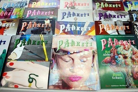 A display rack of Parkett art journals, their colourful covers stacked in rows — a dense archive of contemporary art conversation