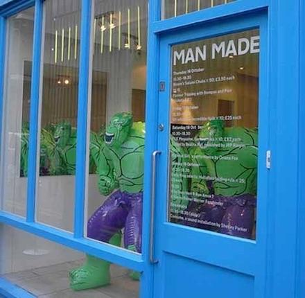 A blue shopfront with MAN MADE in large black letters on the window, inflatable Hulk figures displayed inside — a pop-cultural experiment during Frieze Art Fair